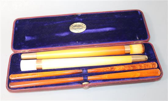 An Edwardian F. Edwards & Co of Glasshouse Street leather cased set of two gold banded meerschaum cigar 10.25in.